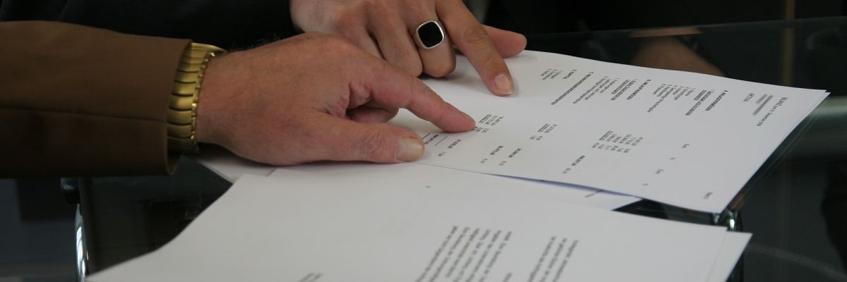 Two people signing a title document